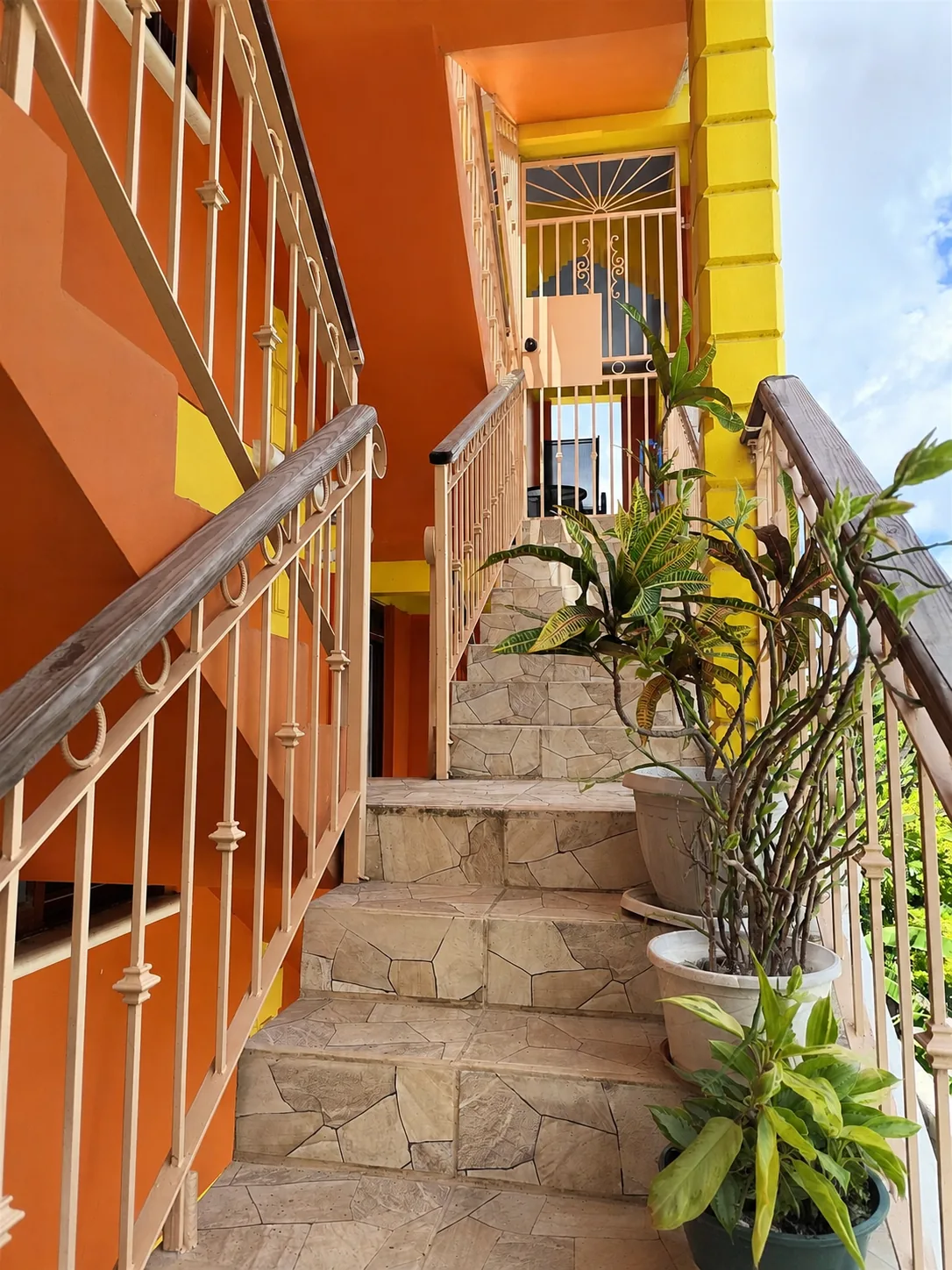 The tiled stairs running down from the apartment level to the street