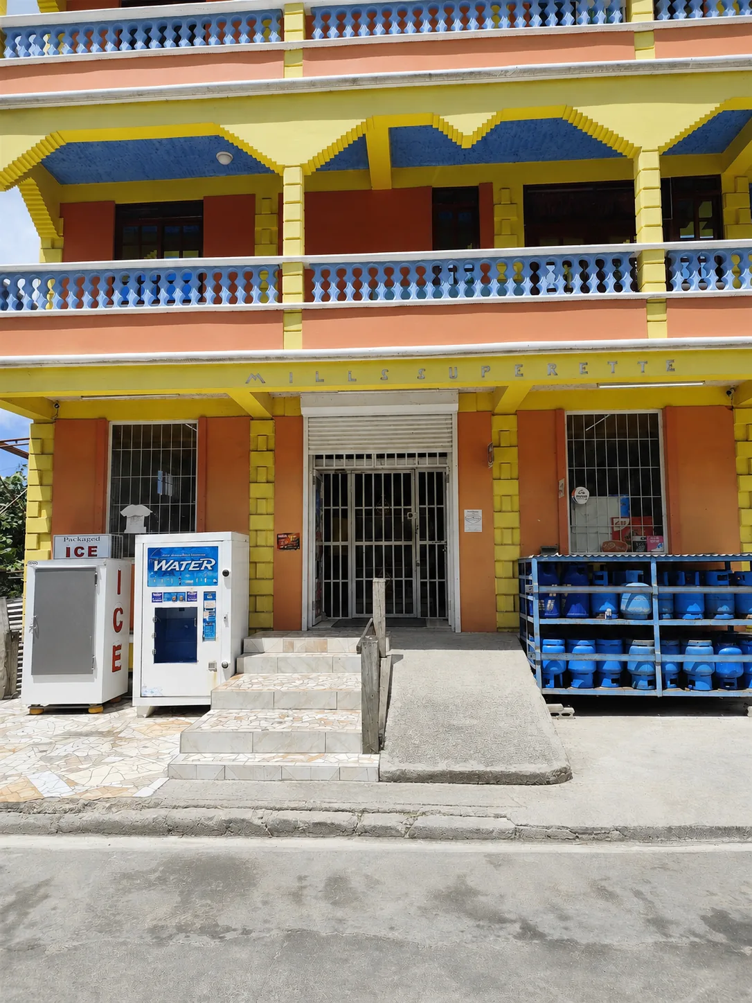 The entrance to Mills Superette at street level